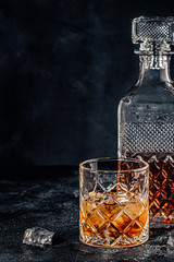 Glass of the whiskey with a square decanter