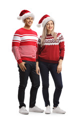 Young man and woman wearing a christmas santa hat and sweaters