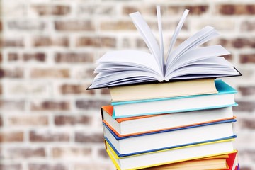 Collection of old books on wall  background