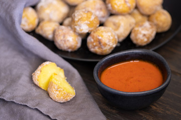 Famous Canary Islands dish, Papas Arrugadas (wrinkly potatoes with salt) and Mojo picon (red sauce) on wood table