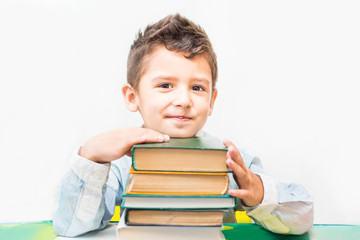 boy with books sitting at the table