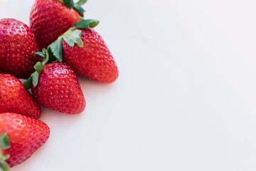 Fresh strawberries on a light background.