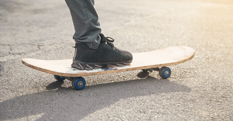 Fototapeta na wymiar Boy rides on skateboard in the asphalt.