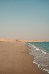 Deserted beach with blue sea in Qatar