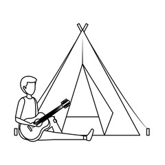 young man playing guitar with camping tent