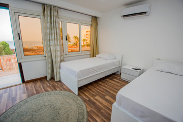 Twin beds in a luxury apartment with sea view