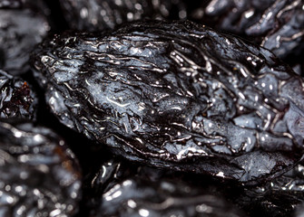 Black dry raisins as background