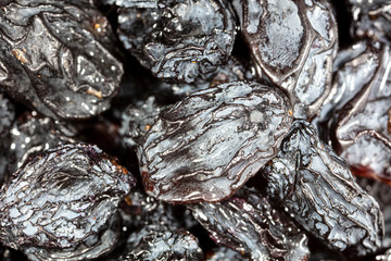 Black dry raisins as background