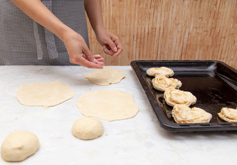 The hostess prepares the pies in the kitchen