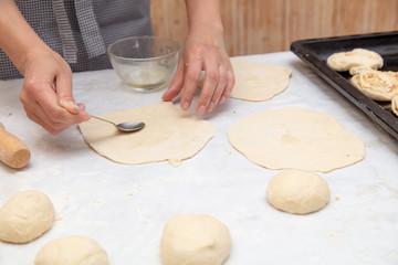 The hostess prepares the pies in the kitchen