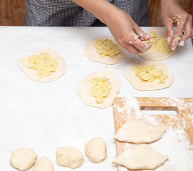 The hostess prepares the pies in the kitchen