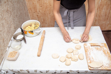 The hostess prepares the pies in the kitchen