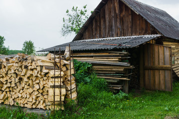 Fototapeta na wymiar Fuel for stove heating at home and bath. Rural life. Wooden firewood is laid in the walls. Natural wood.