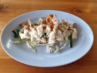salad with  crab legs in the plate