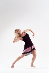 Photo of dancing woman looking away in short black dress