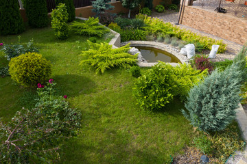 Garden with walkways and green grass. Photo taken from above drone.