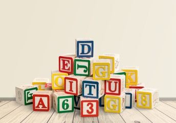 Colorful cubes and Toys collection on wooden table with blurred background