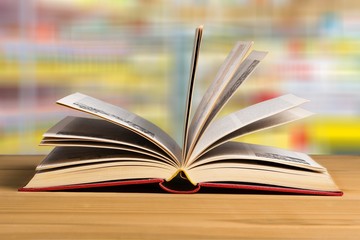 Heap of different books and wooden background
