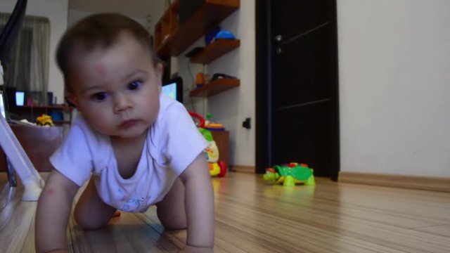 cute seven months old baby boy learning crawling,dolly out shot