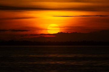 Sunset sky with silhouette cloud and mountain