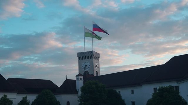 Inside of whe walls of the Ljubljana castle. Ljubljana and Slovenian flags flies in a light breeze.