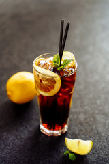 Long Island Cocktail with Lemon Ice Cola Drink. Cool Tea and Rum in Glass on Dark Background. Longdrink Alcohol Soda Brown Hard Drink. Cuba Libre Cocktail Party. Summer Pepsi Refreshing Lemonade