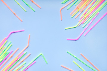Colourful drinking straws on blue background. Cocktail tubes. Place for your text. Say no plastics. Plastic free concept.