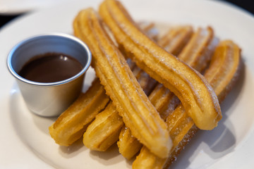 fried-dough pastry—predominantly choux—based snack churros with Chocolate Syrup
