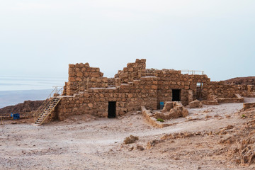 Remains of ancient roman fortification on the plateau on cliff overlooking the Dead Sea coast....