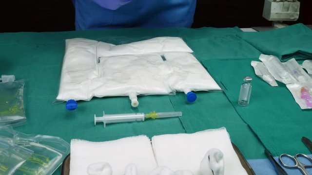 Nurse preparing medication for parenteral nutrition in a hospital, conceptual image