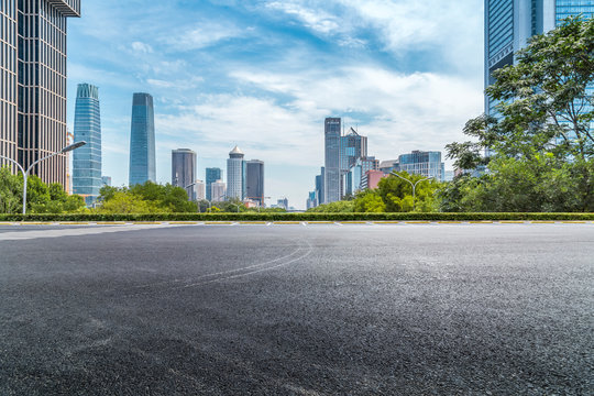 Fototapeta Panoramic skyline and modern business office buildings with empty road,empty concrete square floor
