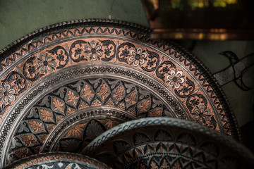 Copper plate handcrafted, traditionally made in Lagich, Azerbaijan. Handmade plate in souvenir shop.