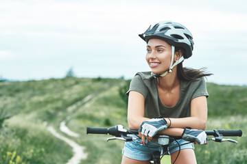 Mountain biking - woman with fatbike enjoys summer vacation. Close up