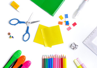 top view on colorful school supplies on white background
