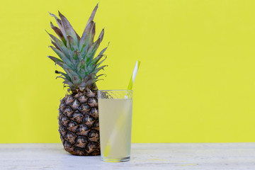 Pineapple juice in glassware on wooden table