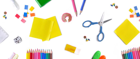 top view on group of colorful  school supplies on white background