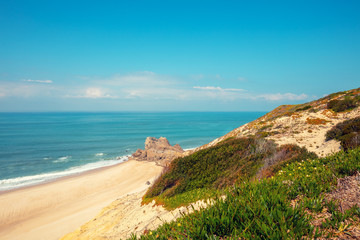 Rocky seashore on a sunny day. Paredes da Vitoria Beach, Portugal, Europe