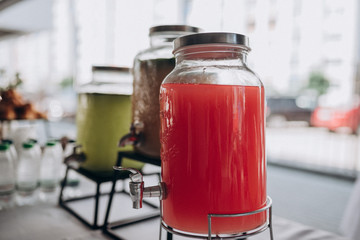 glass jar with cold strawberry juice