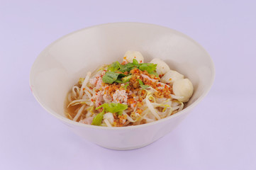 Spicy tom yum noodles with pork, thai noodles, Tom yum pork noodles soup on white background