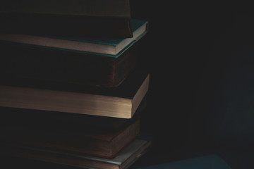 Old vintage books on dark background.
