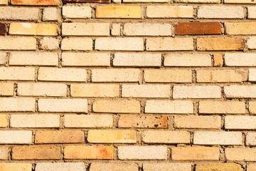 Front view of brown building brick wall .