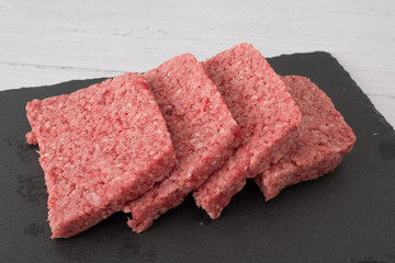 Scottish Lorne or Squared Slice Sausage on a black Slate Board.