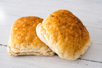 Crusty Bread Rolls on a White wooden Board
