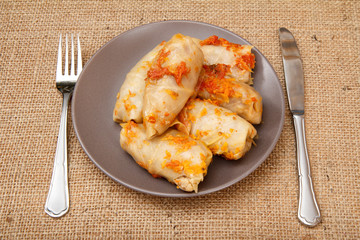 Delicious homemade cabbage rolls stuffed with rice and meat in plate.