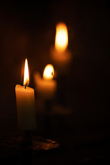 burning candles in church dark environment