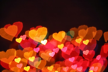 background texture of blurred lights in the shape of hearts