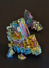 Bismuth crystals on a dark background. This is the most strongly diamagnetic element and also the heaviest that is not radioactive.