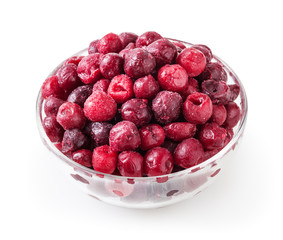 Frozen cherries in glass bowl isolated on white background with clipping path