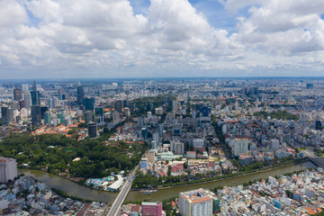 Top View of Building in a City - Aerial view Skyscrapers flying by drone of Ho Chi Mi City with development buildings, transportation, energy power infrastructure. include Landmark 81 and blue sky ,
