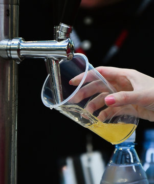 Female Hand Pouring A Beer From A Beer Tap